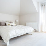 Make your bedroom appear larger by painting it a light colour and minimise wall hangings and clutter.